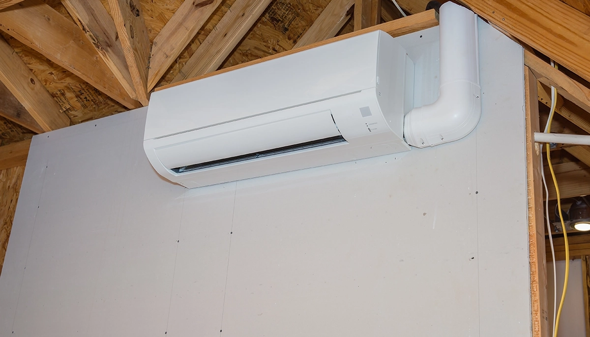 Mini split condensate pump troubleshooting image showing a wall-mounted ductless indoor unit with condensate drain line routing on the side