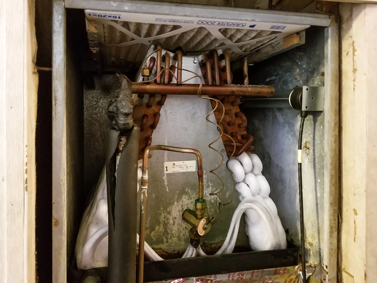 Frozen evaporator coil causing AC freezing up inside a residential air conditioning system